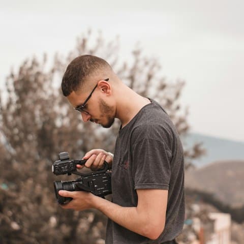 Porträt eines Fotografen, der seine Kamera prüft